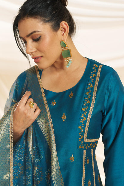 Kayra Teal Sequins Motif Work A-Line Suit Set with Lace Border Detail in Chinnon Silk with Pure Cotton Mul Lining