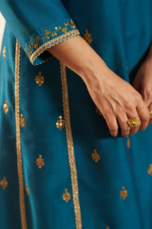 Kayra Teal Sequins Motif Work A-Line Suit Set with Lace Border Detail in Chinnon Silk with Pure Cotton Mul Lining