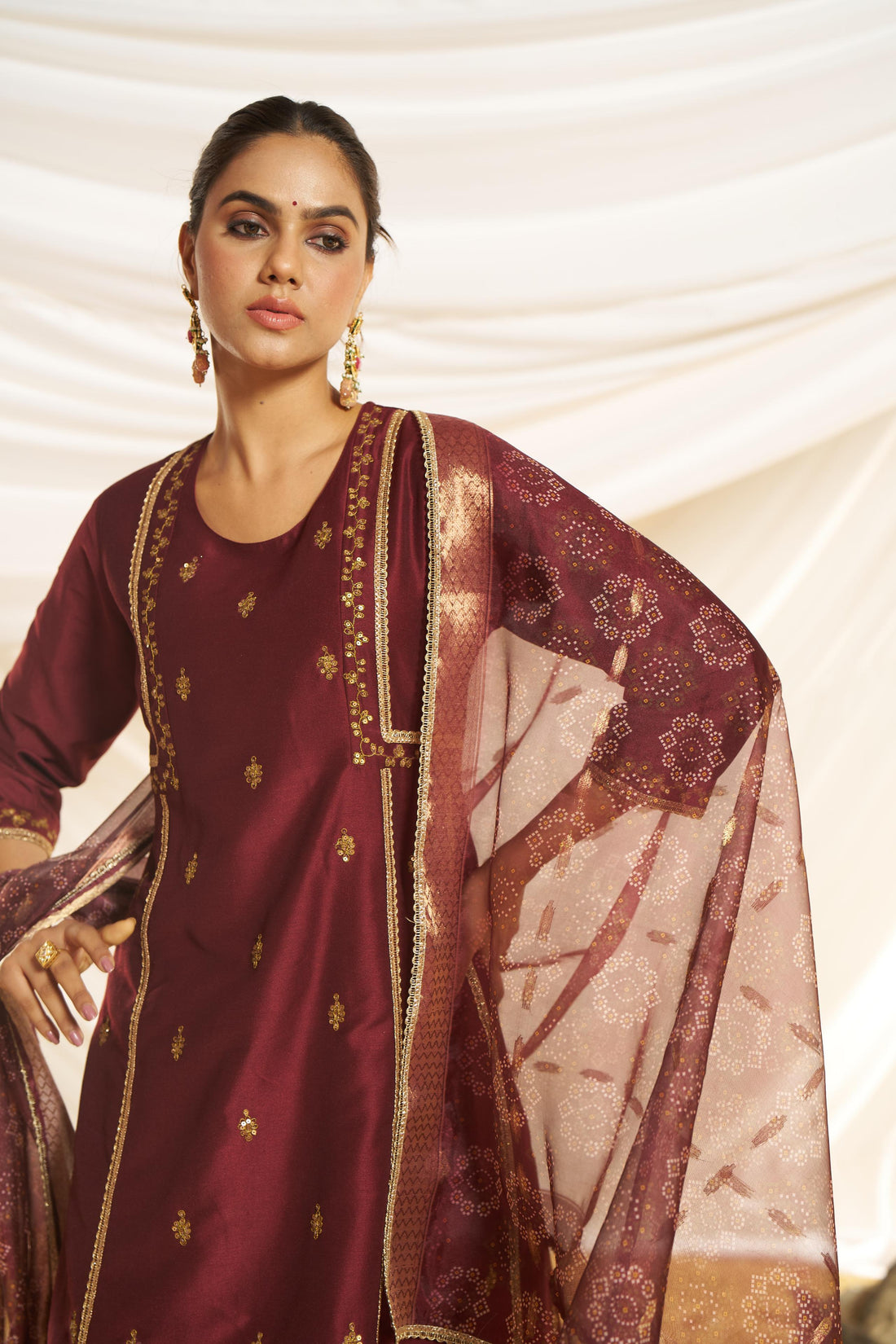 Kayra Maroon Sequins Motif Work A-Line Suit Set with Lace Border Detail in Chinnon Silk with Pure Cotton Mul Lining