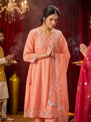 Indu Peach Handcrafted Zari Thread, Sequin & Glass Bugle Embellished Suit Set with Detailed Neckline and Dupatta in Pure Muslin with Pure Cotton Mul Lining